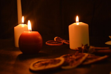 Group of burning candles on black background.