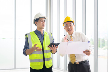 Fototapeta na wymiar Engineering people are analytics construction plans with blueprint in office