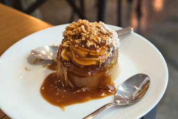 Unusual vegan variation of traditional Hapanese waterdrop mizu dessert - pear jelly with baked apple, caramel syrup, chestnut puree and walnuts