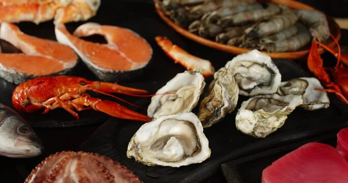 Different types of seafood slowly rotate on the table.