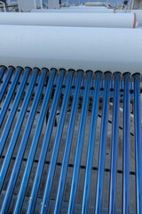 Obraz premium solar panels and tubes installed on roof top of houses and buildings to conserve energy 
