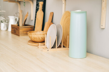 Naklejka na ściany i meble Kitchenware on the wooden table in modern bright kitchen.