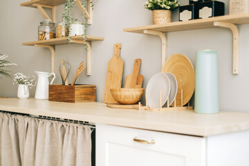 Kitchenware on the wooden table in modern bright kitchen.
