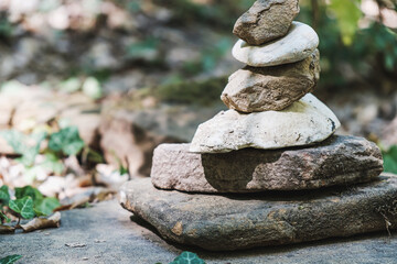 zen stone stack with balanced stones on stones in equilibrium, pile of rocks in the woods