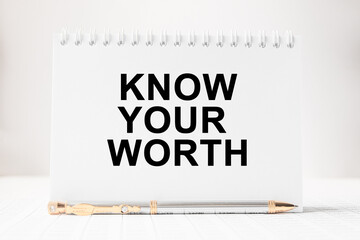 text KNOW YOUR WORTH in a magnifying glass, office concept, business concept, Finance