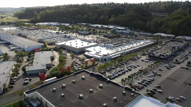 Aerial / drone footage of the shops and businesses, Westfield Southcenter Mall and commercial area, shopping center / mall in Tukwila, Washington