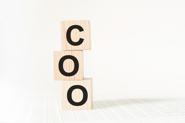 word COO on wooden blocks, white background, business concept. business and Finance