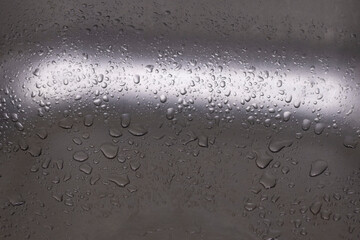 Raindrops on the metal sink.