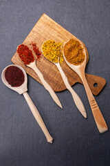 spices and herbs on a dark background. Food and kitchen ingredients. vertical photo