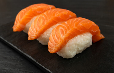 Slices of Raw Salmon Fillet on Black Background Mockup Top View
