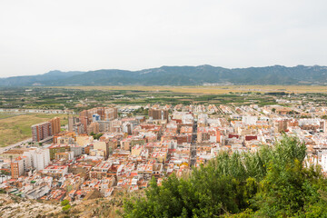 Fototapeta premium Cullera city from an aerial view. Beautiful panorama of the city and the mountains in the background.