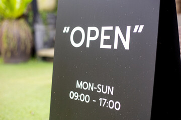 Text on black board open mon to sun at time 09.00-17.00