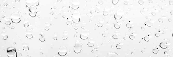 Raindrop water dew drop on glass wet white gray blue background.