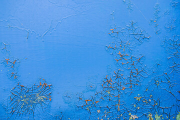 Old dirty painted wall. Several layers of peeling paint. blue. background texture. Horizontal