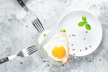 fried egg white and yolk scrambled eggs eat with forks  tasty serving size portion top view copy space for text food background rustic