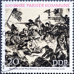 Fototapeta na wymiar GERMANY, DDR - CIRCA 1971: a postage stamp from Germany, GDR showing 100 years of the Paris Commune, 100 years of the Paris Commune, barricade defended by women on Place Blanche