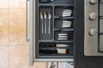Cutlery drawer under gas stove cooker at kitchen