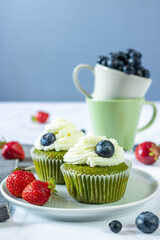 Yoghurt and spinach muffins decorated with blueberries and strawberries