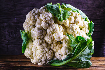 Fresh Raw organic ugly cauliflower on old wooden background . Vegetarian recipe or menu background....