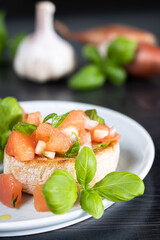 Closeup of a bruschette decorated with basil