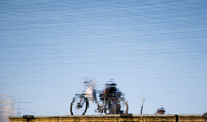 Reflection of a bicycle parked on a platoon pier on a lake