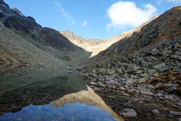 Pond in Valley of Five Spis Lakes surrounded by rocky summits, High Tatra Mountains. Slovakia