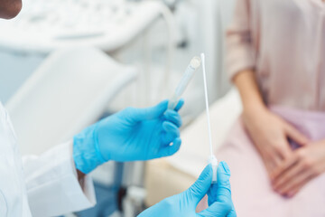 Gynecologist testing vaginal swab for STD - 387821680
