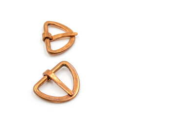 Isolated photos of medieval copper buckles