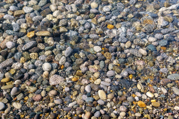 clear sea water on a rocky beach. selective focus