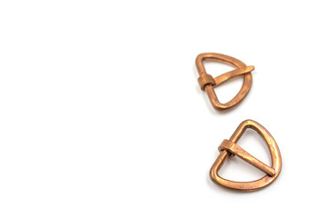 Isolated photos of medieval copper buckles
