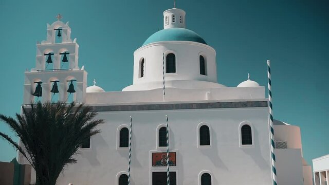 A small orthodox chappel in white and blue in a Greek Island during summer
