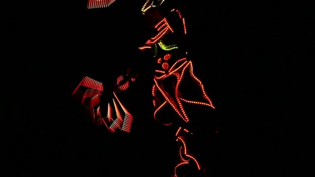 Anonymous artist shows a laser light performance. Light dancer in motion.