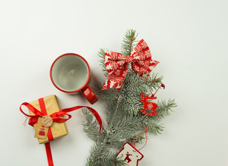 Christmas background. Composition with Christmas gift box, fir tree branch, candy canes and decorations on white background.