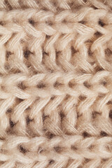 close up texture of knitted beige scarf
