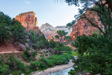 Panoramic view over Zion canyon and Virgin River with a blue sky filled with white clouds taken...