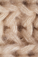 macro texture of knitted beige scarf