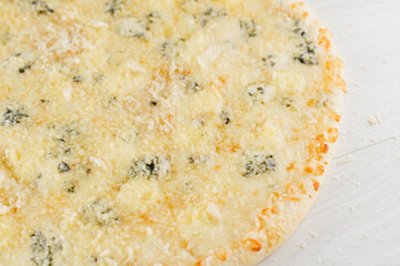 Pizza with cheese such as parmesan, hard cheese, dor blue and mozzarella isolated on white wooden background. Advert for social network of restaurants, caffee. Promotion for pizzeria