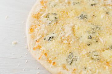 Pizza with cheese such as parmesan, hard cheese, dor blue and mozzarella isolated on white wooden background. Advert for social network of restaurants, caffee. Promotion for pizzeria