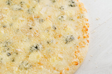 Pizza with cheese such as parmesan, hard cheese, dor blue and mozzarella isolated on white wooden background. Advert for social network of restaurants, caffee. Promotion for pizzeria