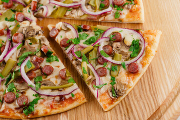 Pizza close-up on white wooden background. Food delivery for people who stay at home. Tasty fast food at quarantine coronavirus covid-19 period.
