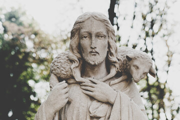 Close up antique statue of Jesus Christ Good Shepherd. In the Christian tradition, a symbol of human importance to God.