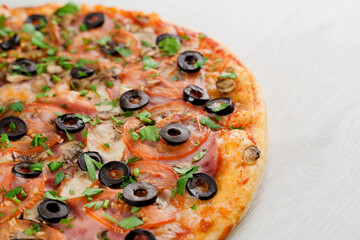 Pizza with meat, olives, tomatoes, mushrooms, herbs isolated on white wooden background. Advert for social network of restaurants, caffee. Promotion for pizzeria