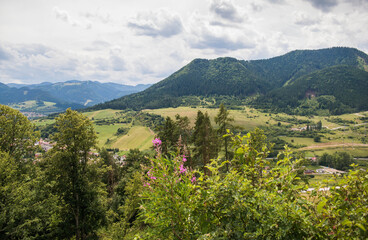 View from Likava Castle to the village of Likavka in Slovakia. Sunny day in the mountains. Mountains overgrown with trees.