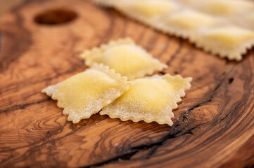Handmade uncooked fresh ravioli with four cheeses filling, tasty vegetarian food