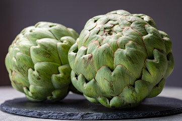 Big ripe uncooked green globe artichoks vegetables