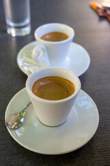 Drinking of strong black espresso coffee on outdoor terrace in cafe