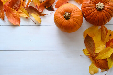 Autumn composition. Pumpkins, fall leaves on white background. Halloween concept. Top view
