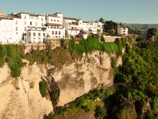 Fototapeta na wymiar Panoramic view at gorge with houses of New bridge in Ronda, one of the famous place in Andalucia. Andalusia, Spain