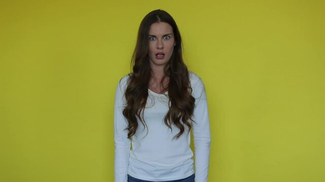 Beauty woman surprised face on yellow studio. Excited model with wow mouth expression. Girl with stress emotion. Amazed people emotion. Astonished person portrait