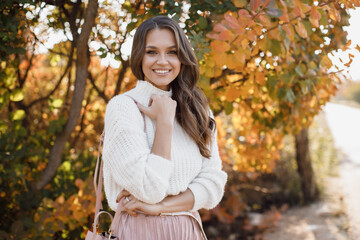 autumn portrait of a happy young woman outdoor